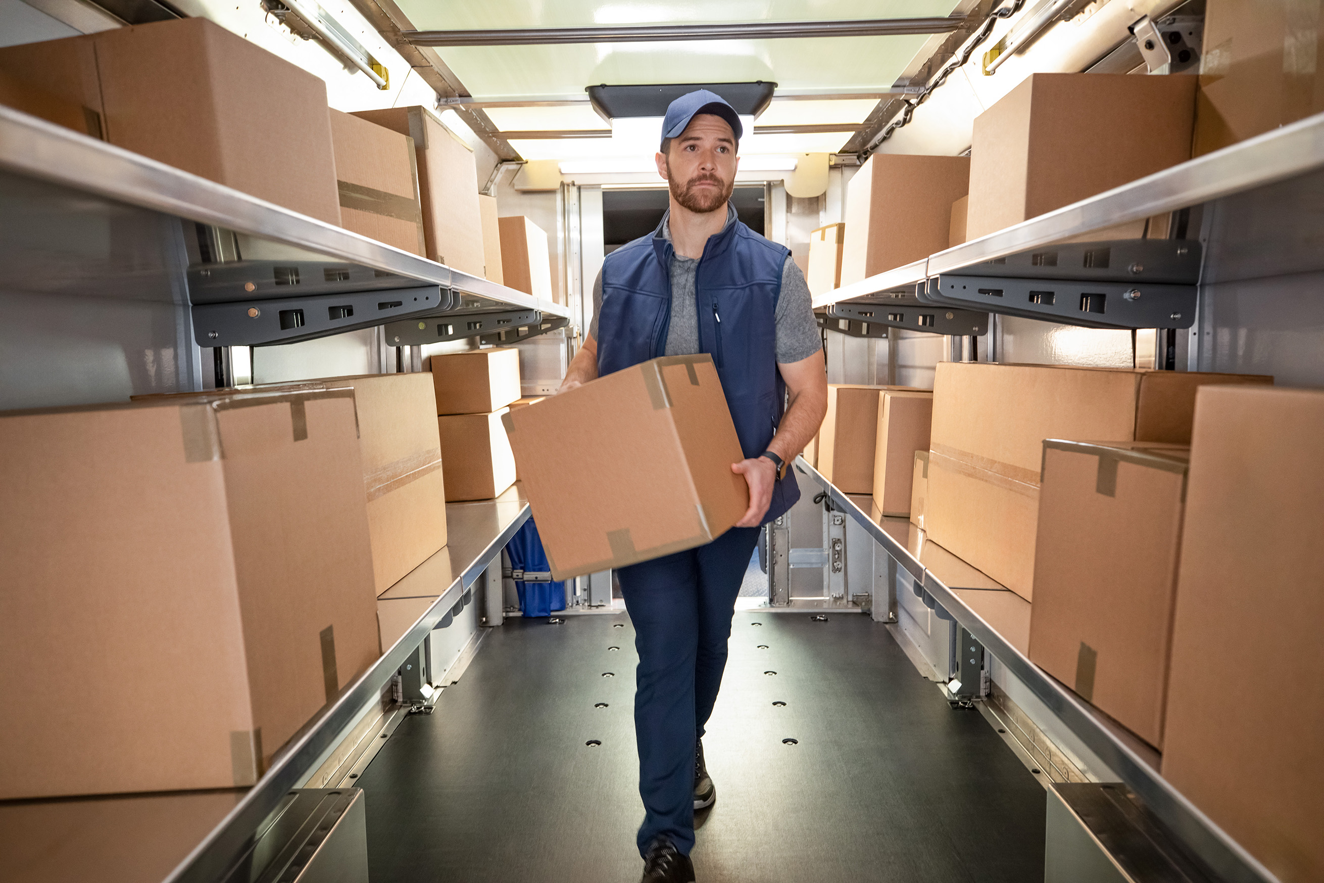 Image of a man carrying boxes inside a BrightDrop.
