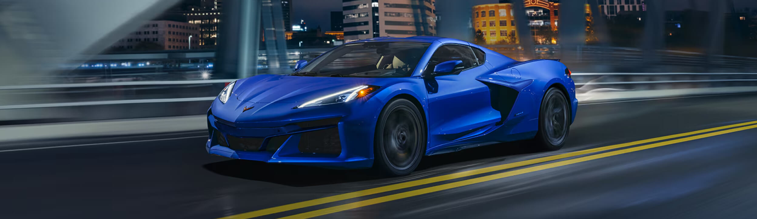 View of a 2025 Blue Chevrolet Corvette E-Ray in an Icy Plain Surrounded by Icy Mountains.