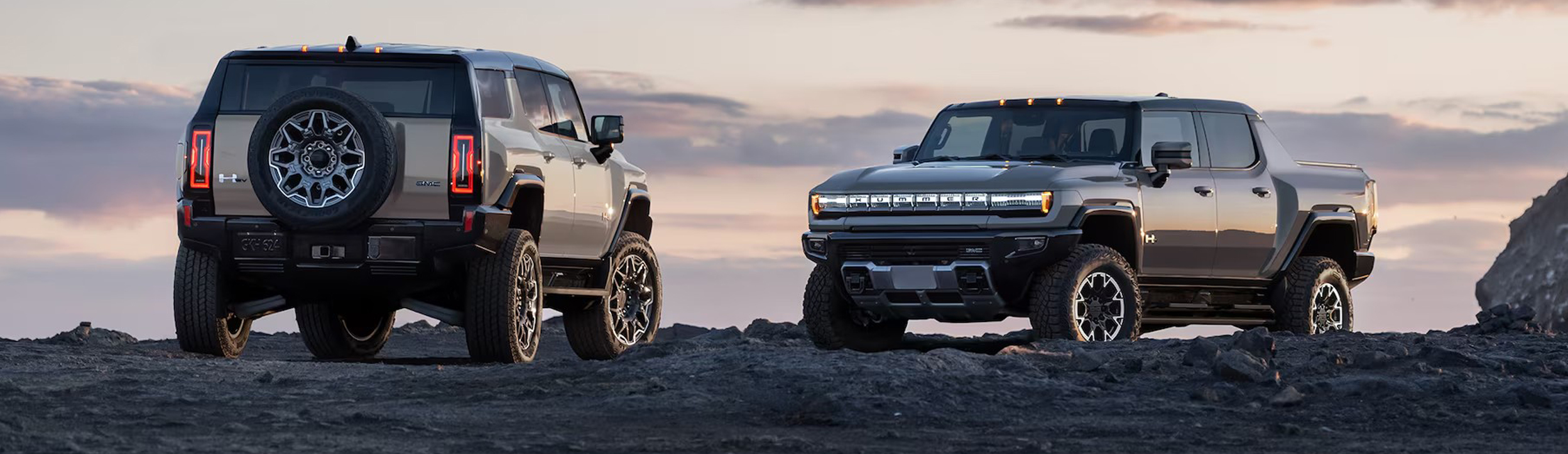 Two 2026 GMC Hummer EVs parked outdoors.
